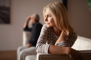 Husband and wife are on a couch, having relationship problems, thinking about Colorado divorce law.